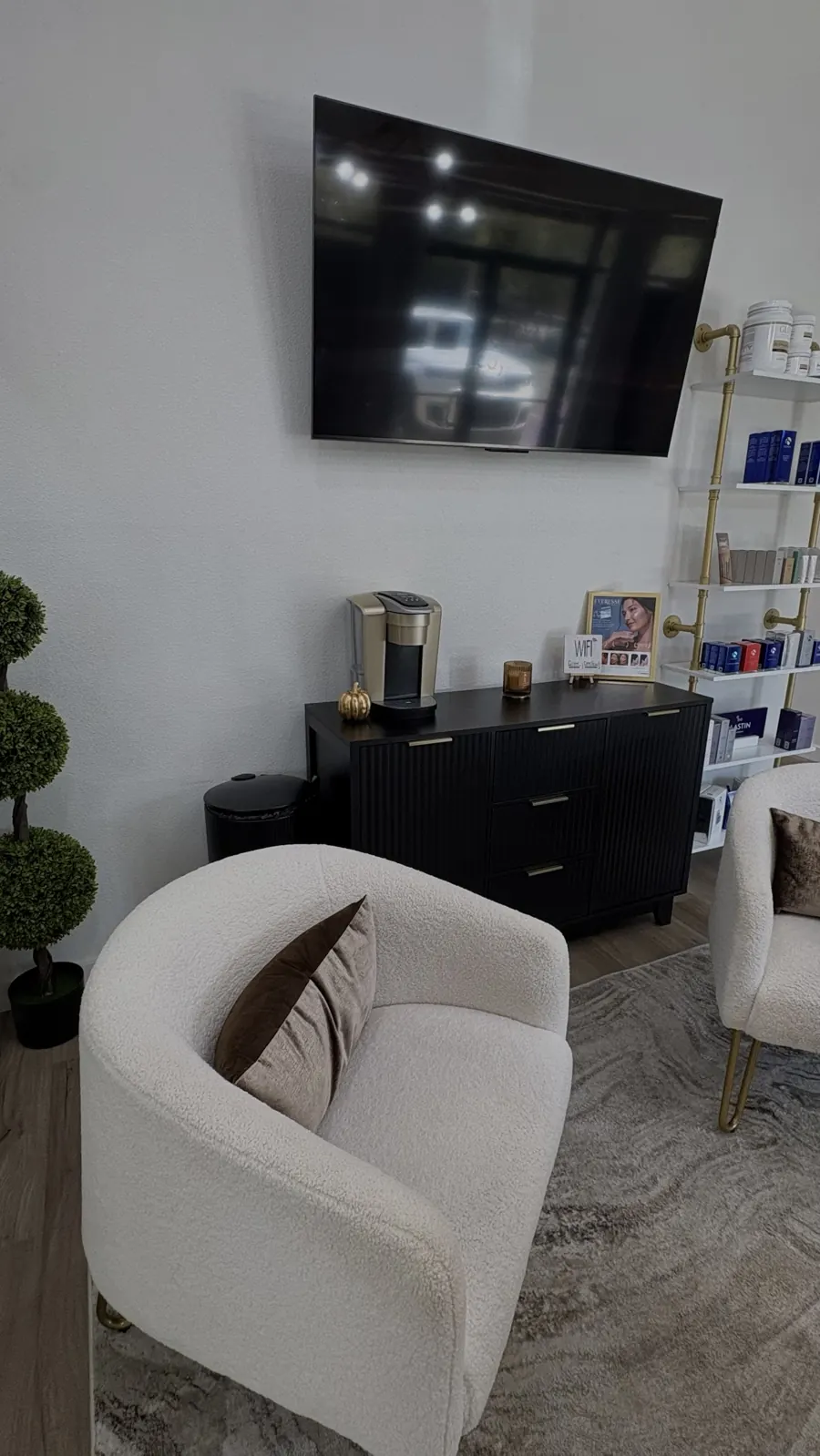 Lounge seating, coffee bar and medical-grade skincare shelves at GLO Aesthetics + Wellness Lounge in Ocala