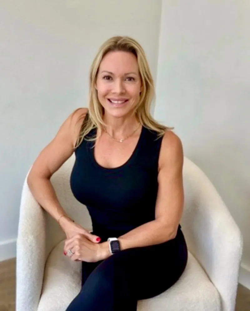 Renee Porter, founder of GLO Aesthetics + Wellness Lounge, seated in the Ocala lounge